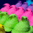 Pixelated image of green foliage with pink and purple floral elements against a dark blue background.