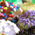 Pixelated static image of a character with brown hair and colorful clothing against a green-yellow background.
