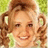 Pixelated image of a smiling person with curly blonde hair styled in pigtails, set against a green background with yellow text reading "Penny Pingleton" and "Hairspray" repeated four times.