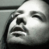 A black-and-white close-up of a person's face with text overlays in purple and white, arranged in a