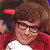 Static image of a person with brown hair wearing red clothing and white collar, smiling slightly in close-up view.