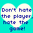 Two identical heart-shaped white text boxes on a cyan background display the phrase "Don't hate the player, hate the game!" in blue pixelated font.
