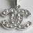 Pixelated grayscale image of a stylized anchor with chain links, rendered in low-resolution digital art style against light background.