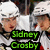 Two pixelated figures in white chef hats and aprons stand side-by-side with a green text banner reading "Sidney Crosby" below them.