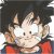 Pixelated static image of a character with spiky black hair, white face, small dark eyes, and red clothing against a dark background.