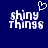 Blue background with white pixelated text 'shiny things' and a heart symbol above the first word, displayed in two side-by-side frames.