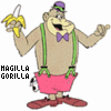Animated cartoon character with light brown skin, green suspenders, pink shorts, red shoes, purple bow tie, and purple cap holding a banana, standing against white background.