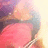 Pixelated image of a figure in pink clothing with blurred background colors including purple, blue, and yellow.