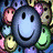A 4-frame contact sheet of animated smiley face icons with varying expressions and background elements, including a central blue smiley surrounded by smaller colorful faces, a large yellow smiley on black with floating small smiles, a yellow smiley sticking out its tongue, and text reading "Smile it's what u do" on a bright yellow background.