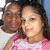 Two people in a close-up photo with one wearing pink and white striped clothing, positioned against a blue background.