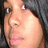 A pixelated close-up of a person with dark hair and light skin, showing subtle facial expression changes across frames.