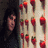 A static image shows a person with long dark hair on the left, red strawberry icons in on a light background, and two figures embracing underwater on the right
