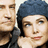 Two people in close proximity, one with dark hair and a blue head covering, the other partially visible on the left.