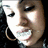 A person with dark curly hair and large hoop earrings appears in three showing slight head movement from left to right