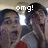 Two pixelated figures with dark hair, one holding a bright white object, under white text reading 'omg!' on a muted background.