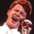 A four- shows a person with light brown hair in white clothing holding a microphone, each displaying different green text overlays