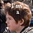 A pixelated image of a person with light brown hair in a gray and white striped shirt, with overlaid text reading "I'm a" and "August Rush <3".