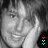 A grayscale portrait of a person with shoulder-length hair resting their head on one hand, accompanied by animated color pixel clusters in the bottom-right corner.