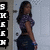 A pixelated image shows a person with long dark hair wearing a purple top and dark pants, standing against a light gray background with vertical black text on the left.
