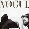 A black-and-white magazine cover featuring a reclining woman in a dark dress with a white top, under large 'VOGUE' text with 'PARIS' in smaller letters above it.