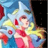 Pixelated static image of a cartoon character with pink hair and red outfit against blue background, surrounded by yellow and red shapes.