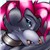 A pixelated static image shows a dark-furred creature with large pink ears and white accents on its face and body, positioned against a light background.