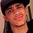 Pixelated close-up of a person wearing dark clothing and a black cap, with visible ear and neck details.