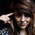 A person with brown hair in a checkered shirt makes a finger gun gesture near their head, with subtle variations in expression and pose across frames.