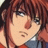 Anime-style character with reddish-brown hair and blue eyes, wearing a red and blue outfit, next to pixelated text on a black background.