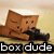 A brown box-shaped character with closed eyes and a small smile lies on a beige background, holding a dark object. The text "box dude" appears below.