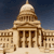Pixelated image of a domed building with columns against a dark blue sky, rendered in beige and brown tones.