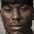 A pixelated image of a person's face with three yellow chevron arrows on a black background, displaying text variations.