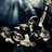 Pixelated image of a dark background with light-colored abstract shapes resembling stylized figures or objects in motion.