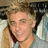 Pixelated image of a person with light brown hair wearing a gray shirt, next to pink text reading 'justin joseph thorne' on black background.