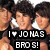 Three people with dark curly hair wear white shirts and black vests; text below reads "I ❤️ JONAS BROS!" in pixelated font.
