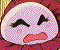 Pixelated cartoon face with closed eyes and open mouth showing teeth, displayed in a