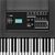Pixelated image of a keyboard with black and white keys and a control panel featuring a cyan display and gray buttons.