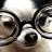 Pixelated static icon of a dog's face with dark and light brown tones, featuring visible eyes, nose, and mouth in low-resolution detail.