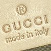 Beige textured background with brown text reading 'GUCCI' and 'made in Italy' beneath a registered trademark symbol.