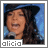 Alicia Keys in a blue hat singing into a microphone with a blue background, displayed in a of showing sequential facial expressions