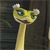 Pixelated yellow-green cartoon character with large eyes, small ears, and a long neck against a dark background.