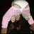 A pixelated figure with light skin wears a white cap and pink long-sleeve shirt, arms raised in a dynamic pose against a dark background.
