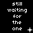 Black background with white pixelated text reading 'still waiting for the one' and changing symbols below.