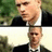 Pixelated static image of a man in formal attire with dark hair and light skin, positioned against green foliage background.
