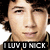 Pixelated close-up of a person's face with dark hair, wearing a black shirt and displaying text 'I LUV U NICK' at the bottom.