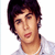Two side-by-side pixelated frames of a person with dark hair wearing a light-colored collared shirt against a white background.