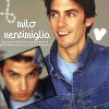 Two people in blue denim jackets appear in a static image with text 'milo ventimiglia' and a white heart symbol on a gray background.
