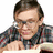 A pixelated image shows a person in a checkered shirt holding an object, with pink text and symbols on the right side.