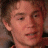 A pixelated image split into two sections: a person's face on the left and green text on a dark background on the right.