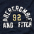 Pixelated graphic with dark background showing '92' in yellow, white text forming a semicircle above and below, and yellow text reading 'yeah baby!' on the right.